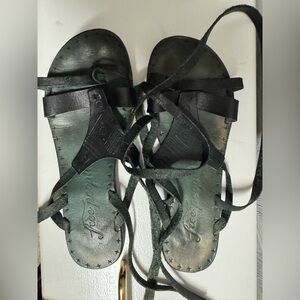 Ladies black Free People leather wrap around ankle sandals.